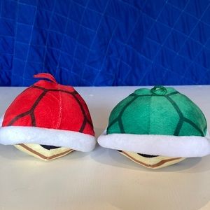 Two plush Mariokart shells, one green one red